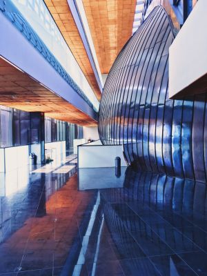 The interior of the Faculty of Law and Administration with the view for round metal walls of Auditorium Maximum and the corridor in front of it.