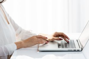 A woman’s hands on a laptop keyboard