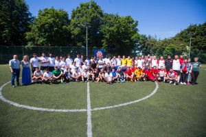 A group photo of participants of the 2019 Euroasmus and Friends Cup. The photo was taken on a football field.