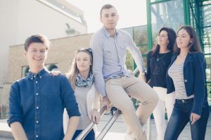 AMU Students sitting on a stairs in fromnt of Collegium Physicum at Morasko Campus