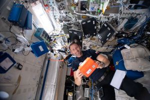 Astronaut Sławosz Uznański-Wiśniewski conducting experiment at the International Space Station