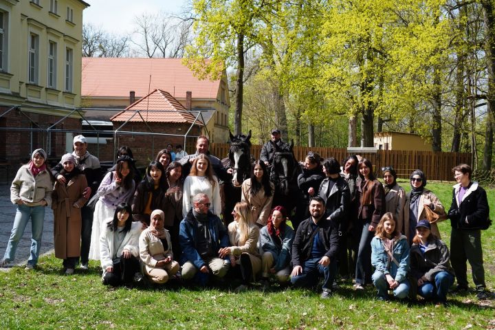 A group of foreign AMU students at the horse stud in Sieraków
