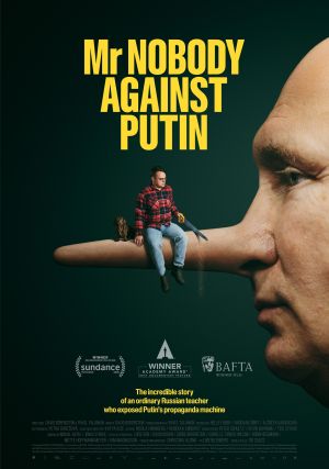 Movie poster for the documentary “Mr Nobody Against Putin.” The poster features a large close-up side profile of Vladimir Putin’s face with an exaggeratedly long Pinocchio-style nose extending across the image. Sitting on the nose is a small man in a red plaid shirt holding a hand saw, alongside a dachshund dog. Bold yellow text at the top reads “Mr Nobody Against Putin.” At the bottom are award logos including Sundance Film Festival, Academy Award for Best Documentary Feature, and BAFTA, along with a tagline describing the story of an ordinary Russian teacher exposing Putin’s propaganda machine.