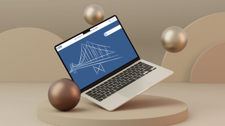 A laptop floating against a birch background, surrounded by decorative spheres, displaying the MOS electronic system website